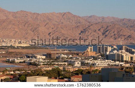 Panoramic view of the tourist center of Eilat, Israel's southernmost city, and of the northeastern tip of the Red Sea. Aqaba, the only coastal city in Jordan, and mountains are in the background.