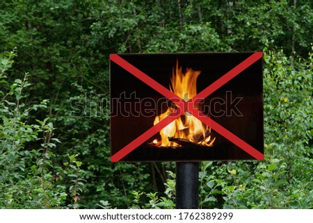 sign depicting a crossed out fire forbidding to make fire in the forest