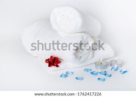 Spa towels, towels roll with hearts in the hotel's bedroom for design and decoration on white background.Copy space.Concept Happy Valentine's Day, wedding, honey moon or birthday. 
