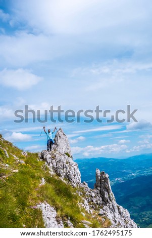 Mount Aizkorri 1523 meters, the highest in Guipuzcoa. Basque Country. Ascent through San Adrian and return through the Oltza fields. A young man waving from the top of the mountain