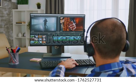 Colorist in wheelchair using editing software.
