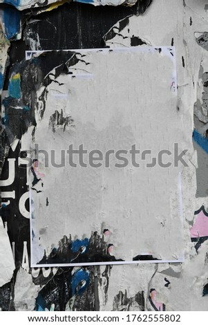 Torn and ripped wall of old street posters, creative urban paper pattern