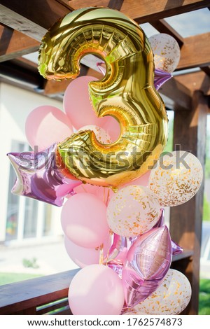 Birthday pink and golden balloons with confetti and balloon number three