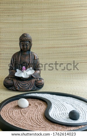 Spirituality and relax concept. Buddha figure with orchid flower