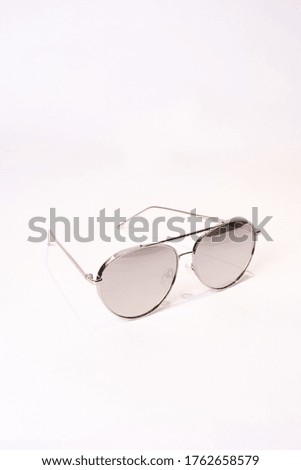 A vertical shot of aviator sunglasses isolated on white background