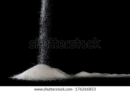 sweet sugar trickles on a pile with black background Royalty-Free Stock Photo #176266853