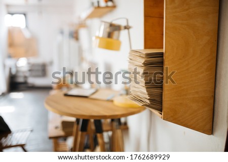 stack of letters on a wooden shelf against the background of the interior