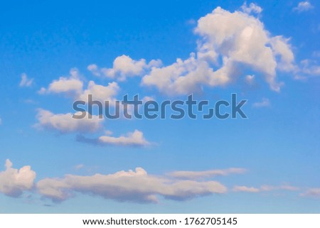 
Cumulus white clouds in the blue sky before the rain
