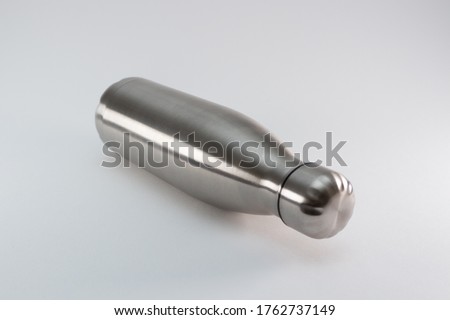 Metal flask, bottle for preservation of a hot or cold liquid on a white background.