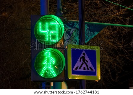 Green Pedestrian in traffic light at night
