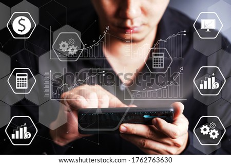businessman hand working on smartphone with digital layer business strategy and social media diagram on wooden desk. new technology bigdata and business process strategy.