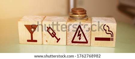 Bad habits icones on natural wooden blocks. Drinking, using drugs and smoking danger icons. Prevent addictions healthcare concept.