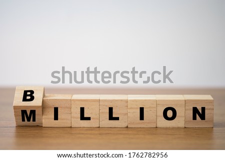 Flipping of wooden cube block for change million to billion. Business and investment growth concept. Royalty-Free Stock Photo #1762782956