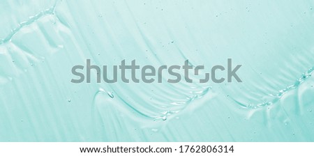 Cosmetic gel texture. Sanitizer, antibacterial clear blue gel waves background. Skincare transparent creamy product with bubbles Royalty-Free Stock Photo #1762806314
