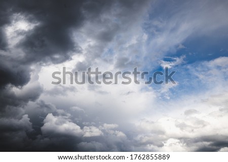 gloomy clouds covering the blue sky