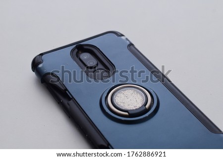 Backside of handphone with broken casing on the side. Selective focus image