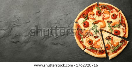 Top view of hot delicious pizza on dark table, space for text. Banner design 