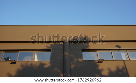 industrial warehouse dark facade against sky background
