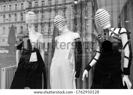 Mannequins in a display window with city reflections in black and white, Vienna, Austria.