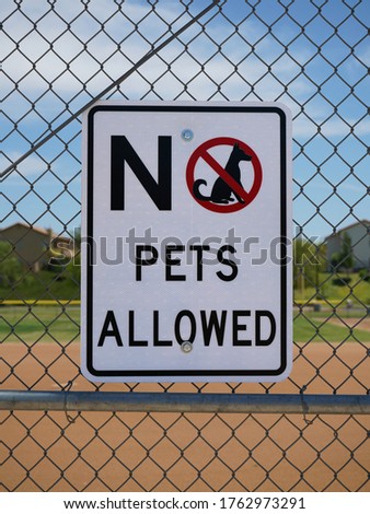 No pets allowed sign on a fence.