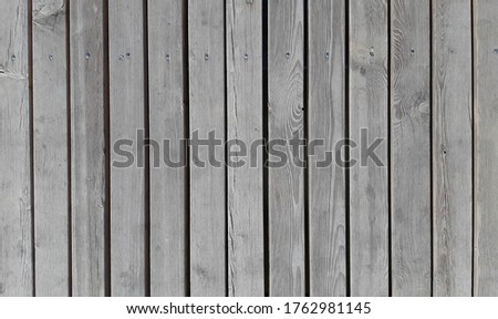 Textured gray boards with nails
