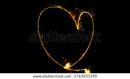 Heart shape made with sparkler in the new years night
