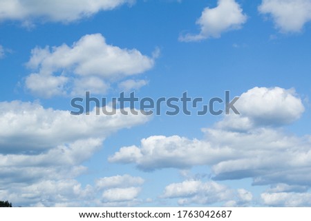 white fluffy clouds on a blue sky