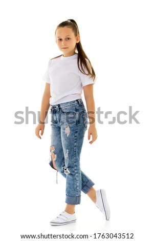 Little girl in a pure white T-shirt for advertising and jeans.