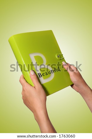 A girl holding a book with a beautiful theme