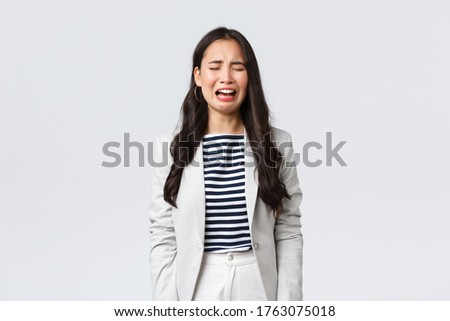Business, finance and employment, female successful entrepreneurs concept. Uneasy distressed asian office lady feeling sad, crying and sobbing, standing depressed over white background