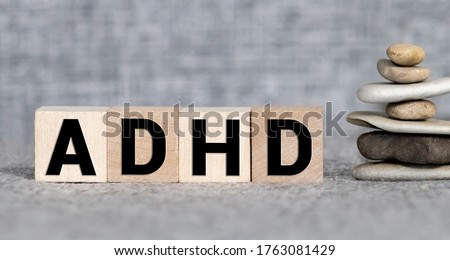ADHD abbreviation on wooden blocks. ADHD is Attention deficit hyperactivity disorder. Close up. Vignette. Royalty-Free Stock Photo #1763081429