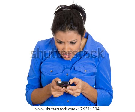 Closeup portrait of young upset worried disgusted  stunned woman seeing bad news email text on mobile cellphone, isolated on white background. Negative facial expressions, emotion feeling
