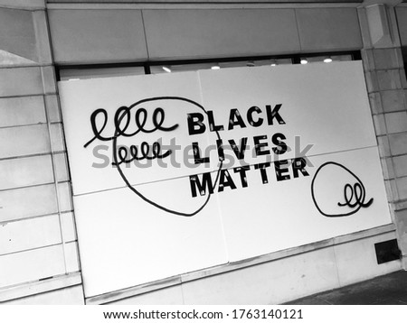 Black Lives Matter signage boarding up a window in Seattle, United States (Black and White photo)