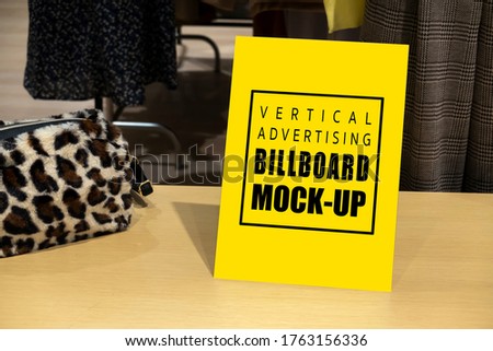 Mock up blank signboard with clipping in acrylic frame, on shelf show fashion bag at ladies costume store, empty space for insert advertising or announcement information promotion