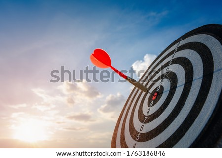 business marketing as concept. Red dart arrow hitting in the target center of dartboard Target hit in the center. Royalty-Free Stock Photo #1763186846