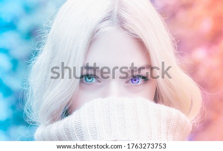 A picture of a beautiful woman with an ode-eye editing. A beautiful blonde woman with a gradient expression of warmth and coldness.