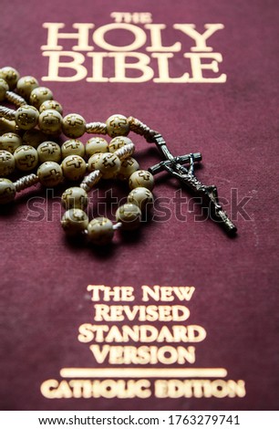 Holy Bible with rosary. Crucified Jesus on Holy Bible 