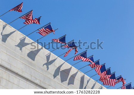 American flag on the mast, roof of the building, Los Angeles, California, USA.
