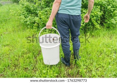 Man holds a compost bucket. Zero waste. Ecological lifestyle. Environmental pollution. Fertilizer for the farmer.