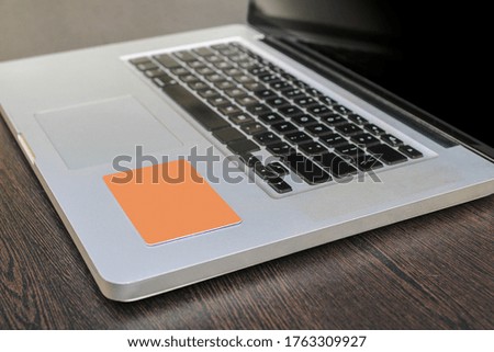 A credit/debit card on a laptop on a wooden table