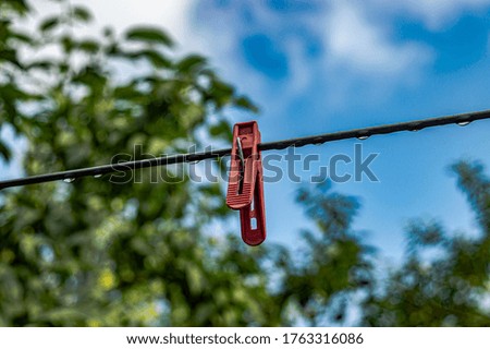 clothespin with raindrops on sky nature background
