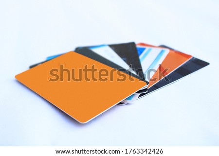 Group of multicoloured credit/debit cards on white background