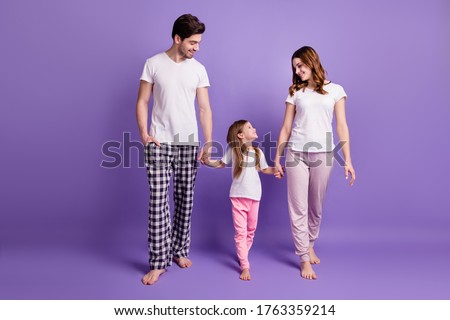 Full length body size view of nice cheerful careful lovely family mom dad offspring daughter wearing sleepwear going bed time isolated on bright vivid shine vibrant violet color background Royalty-Free Stock Photo #1763359214