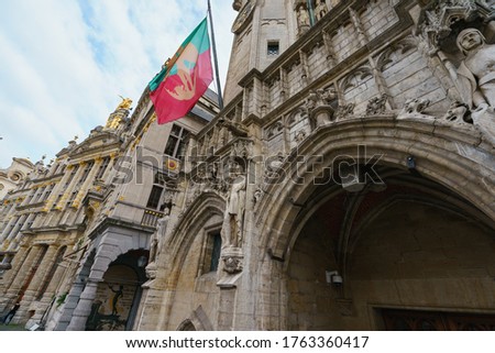 Details of the medieval architecture in Brussels. Stone building facade. Heritage and touristic concepts. City Brussels flag. Photography in summer day