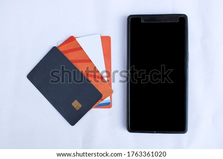 Credit/debit cards with mobile phone on a white background