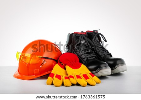 Protective helmet, boots, gloves and glasses. Standard construction safety. Royalty-Free Stock Photo #1763361575