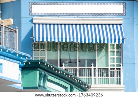 blue and white striped awning over the store window.
