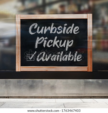 A business sign that says ‘Curbside Pickup Available’ on the window. Royalty-Free Stock Photo #1763467403