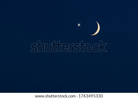 Crescent moon with star on dark-blue sky, picture for Ramadan or Ramazan
