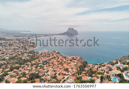 Aerial photography panoramic image Calpe or Calp townscape rooftops picturesque view bright Mediterranean Sea waters and Parque natural Peñón de Ifach or Penyal de Ifac rock, Costa Blanca, Spain